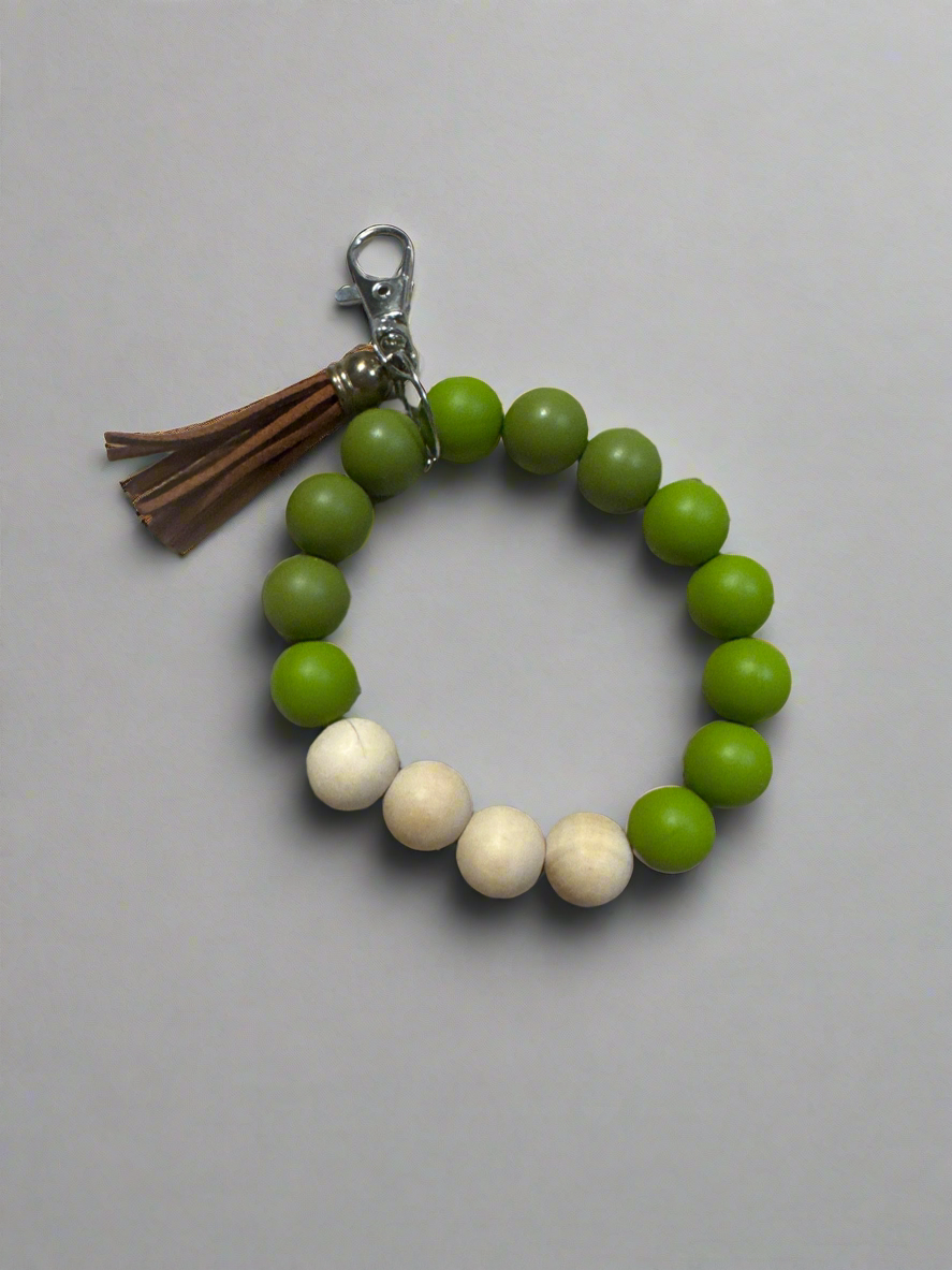 green silicone bead wristlet keychain bracelet with wood beads and brown tassel
