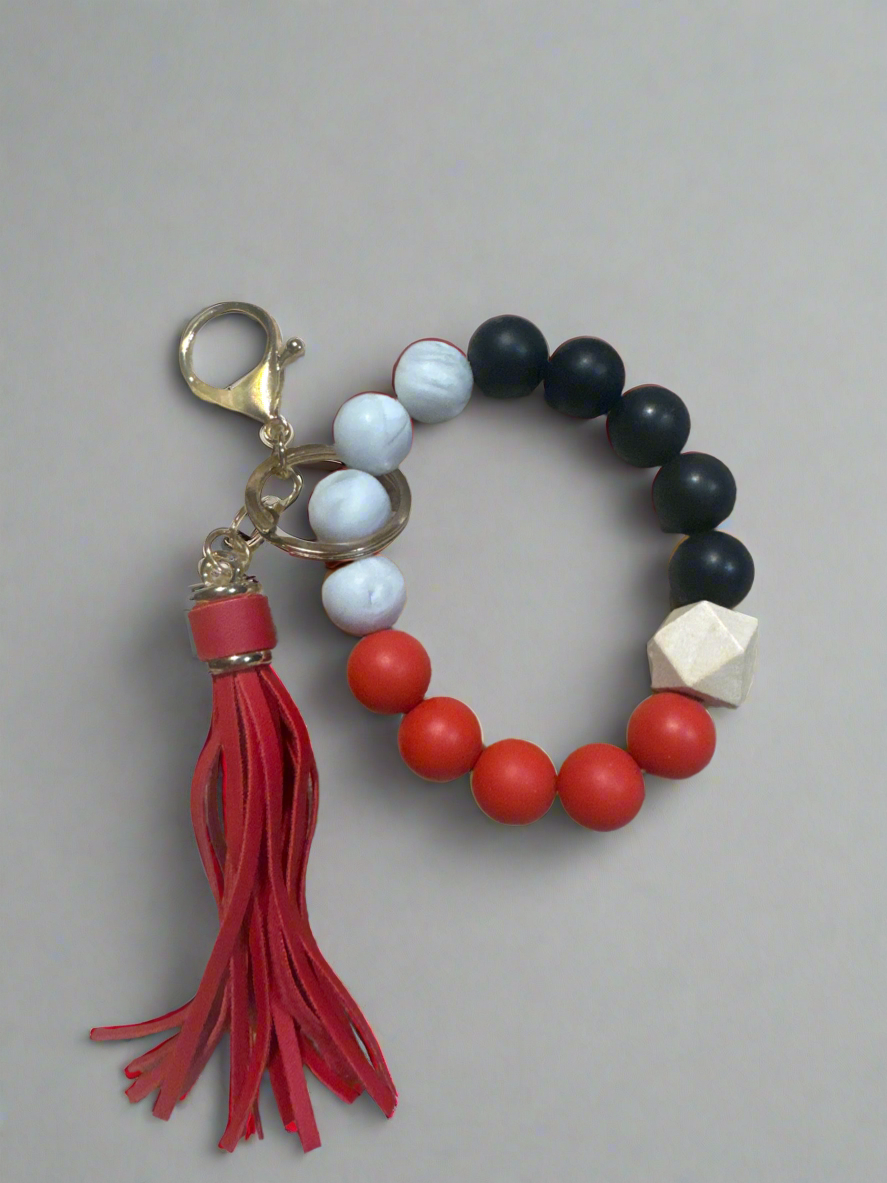 green silicone bead wristlet keychain bracelet with wood beads and brown tassel
